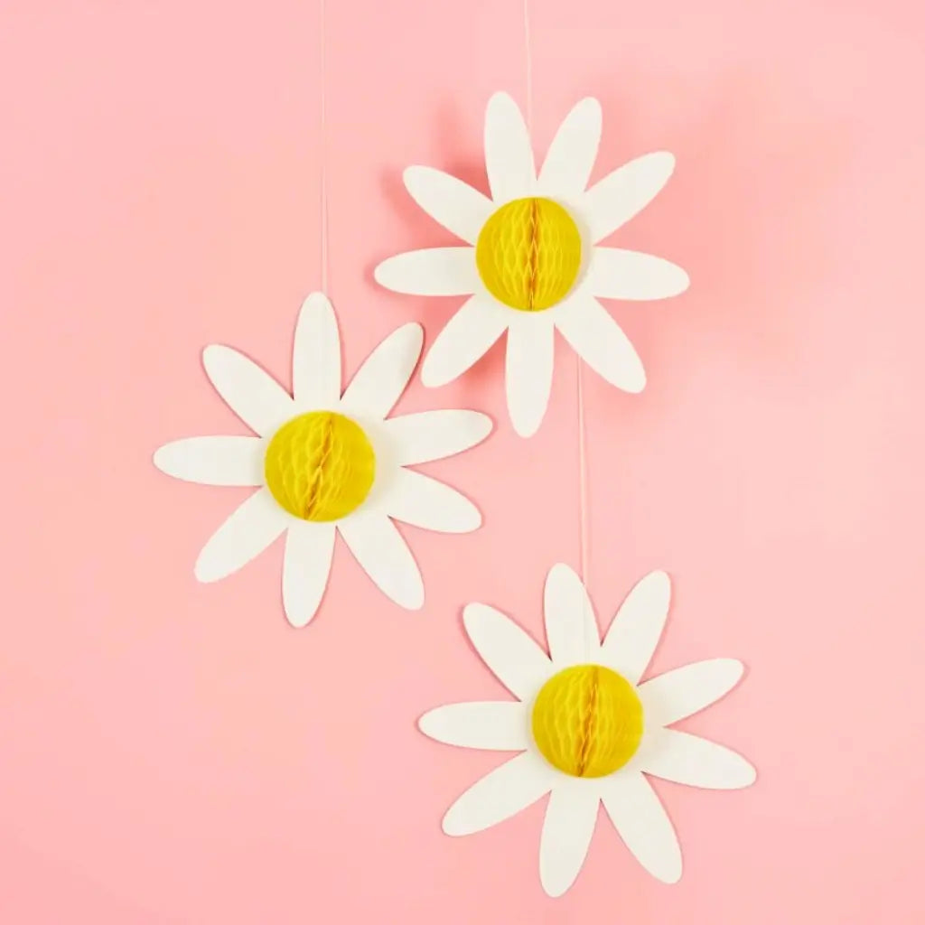 White daisy paper honeycombs with yellow centre for floral party decor