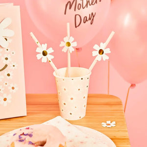 Pastel pink daisy party cups matching floral plates and napkins