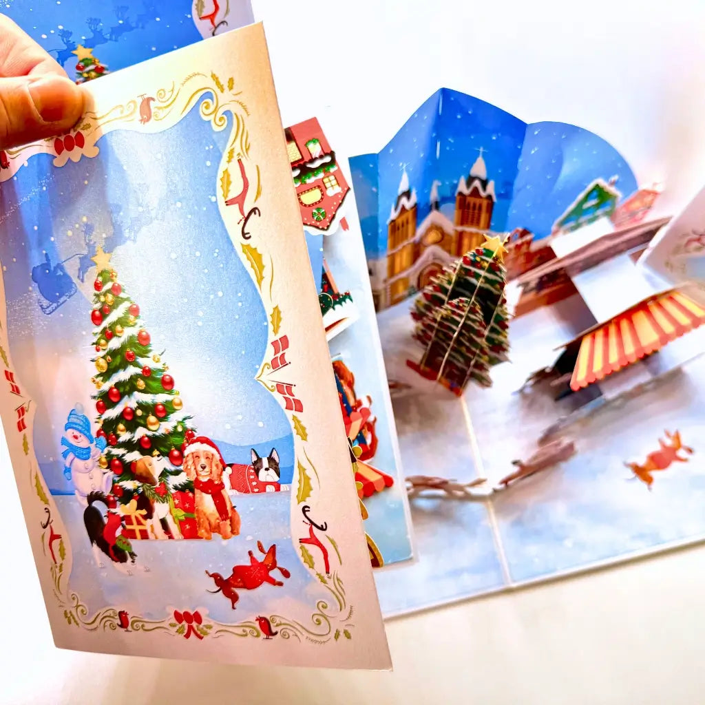 3D pop-up Christmas card featuring dogs in snowy amusement park