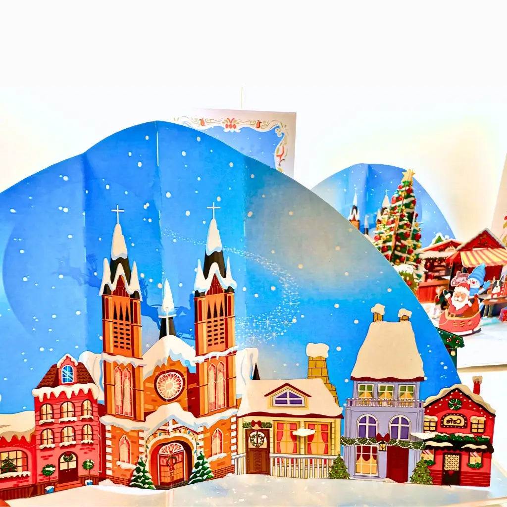 Whimsical 3D snowy village card with dogs enjoying holiday fun