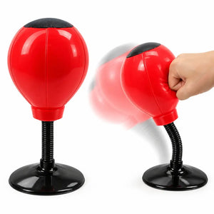 Red desktop punching ball with a black spring and suction cup base