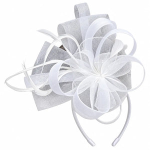 Modern white fascinator featuring wide loops and curled feathers