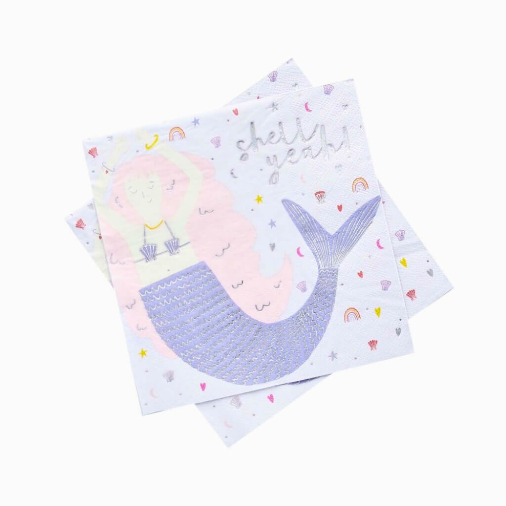 Ocean themed mermaid kids party table setup with mermaid napkins