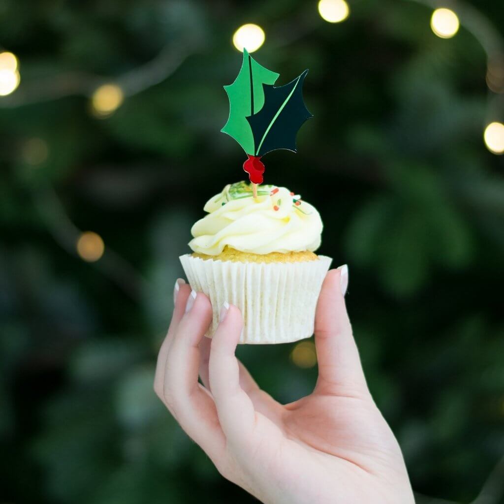 Red and green foil holly and berry cake toppers on wooden sticks for Christmas desserts