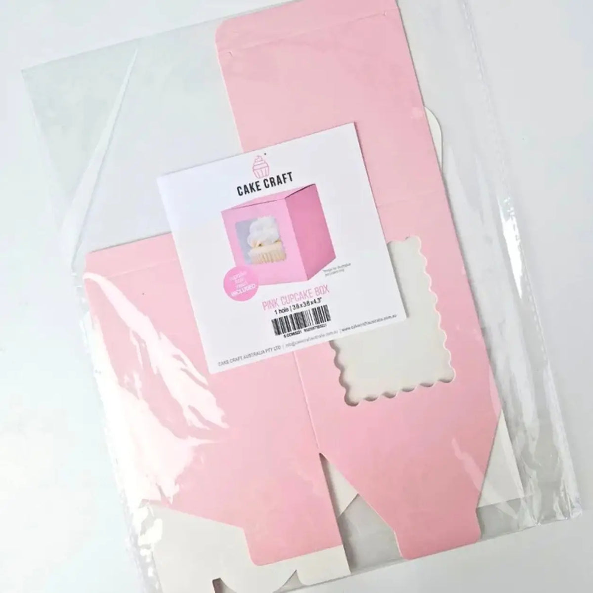 Flat-packed pink packaging box for one standard cupcake