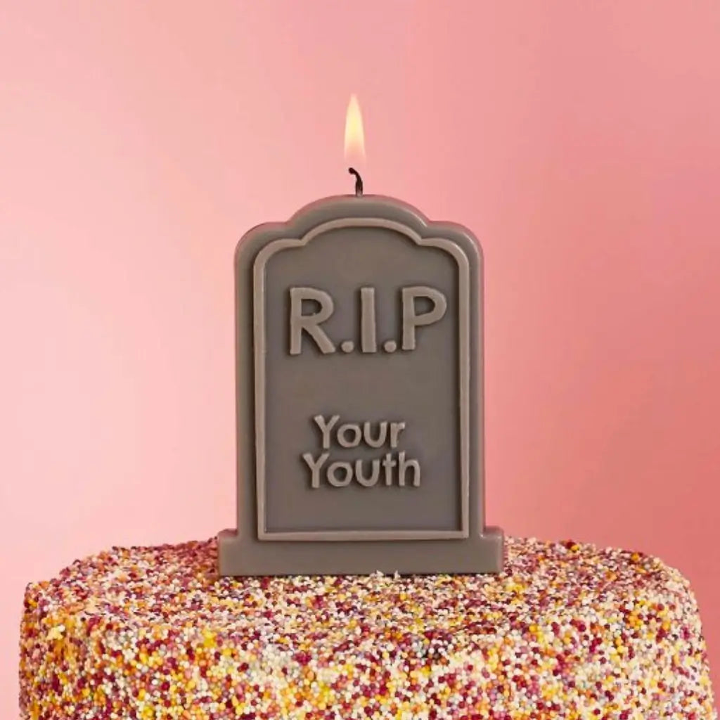 RIP Your Youth candle displayed on a birthday cake