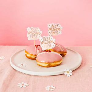 Pink and white daisy food picks for brunch party table styling