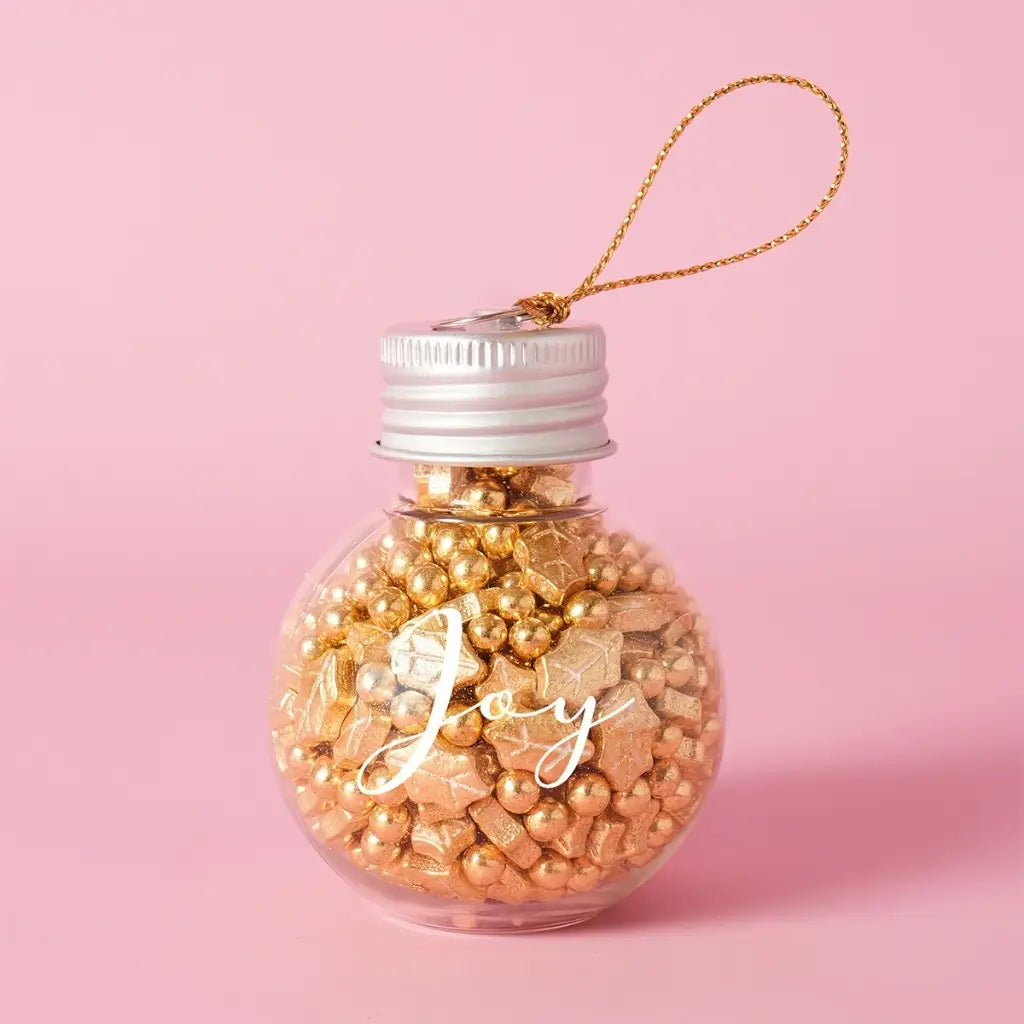 Glass JOY bauble filled with gold sprinkles and a hanging cord
