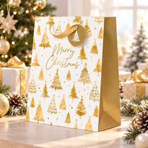 large white gift bag with gold Christmas trees and Merry Christmas wording