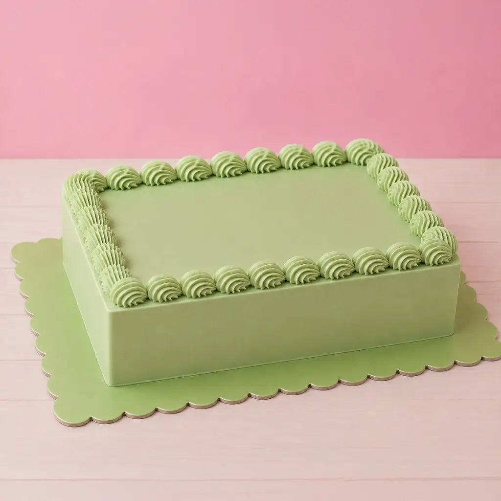 Reversible pink and green rectangle cake board with scalloped edges