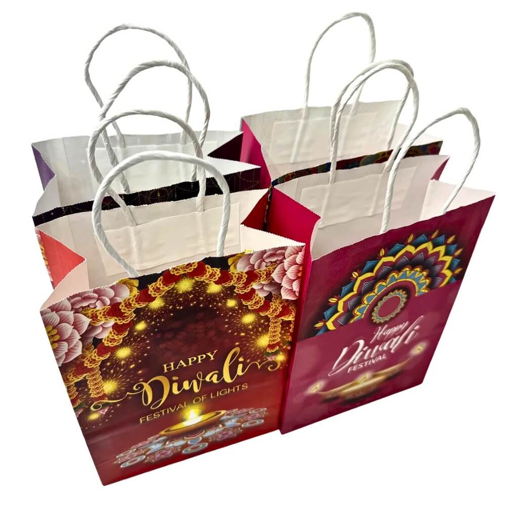 4 Diwali-themed paper bags with decorative designs and text on a white background.