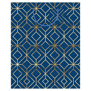 Large navy blue gift bag with gold geometric foil pattern, ribbon handles and matching gift tag