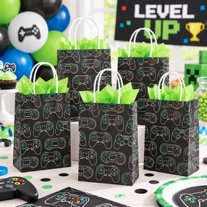 Black gaming controller paper party bags filled with small birthday favours and treats at a gamer-themed party
