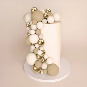 champagne gold cake ball toppers set on cake