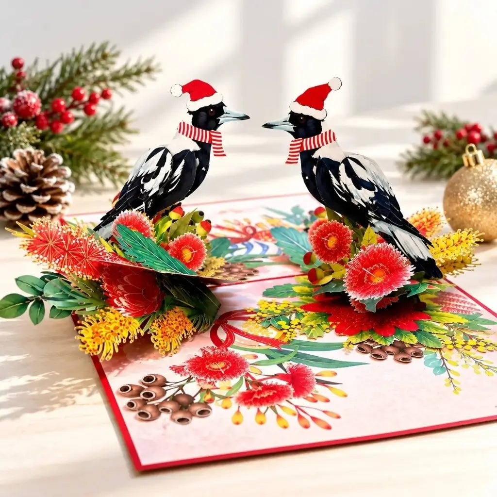 Two festive Australian magpies wearing Santa hats and striped scarves