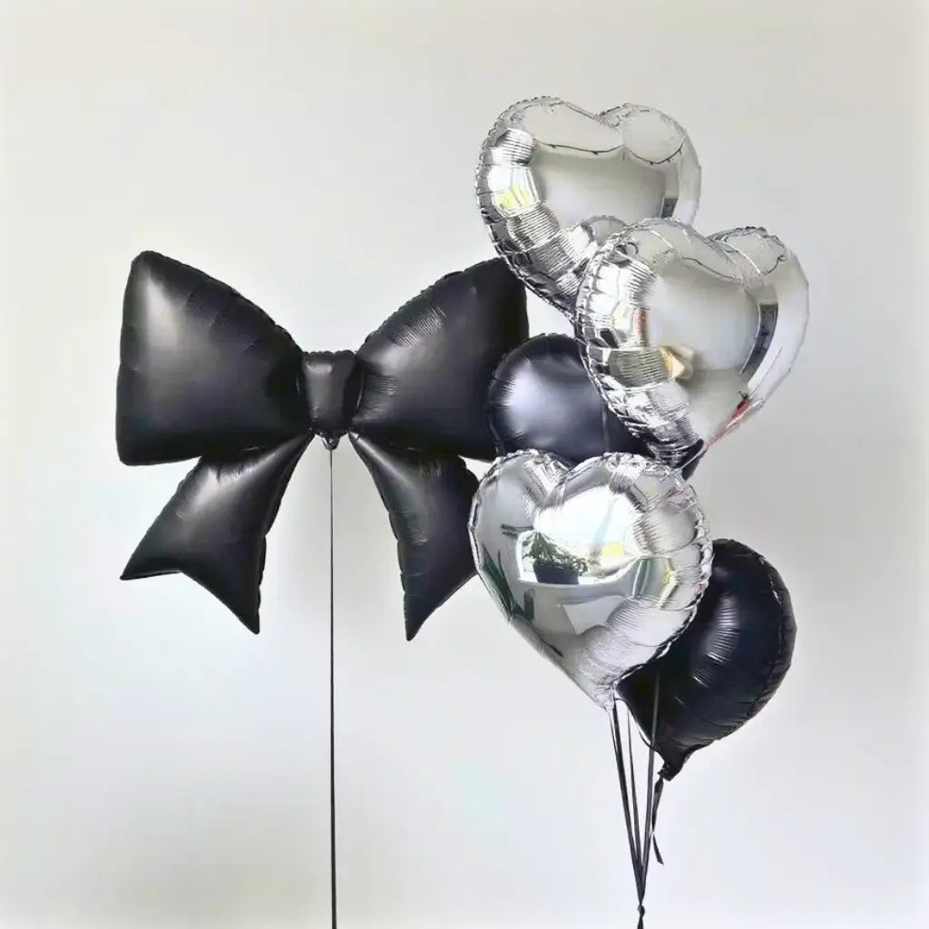 Jumbo black ribbon bow foil balloon with silver hearts