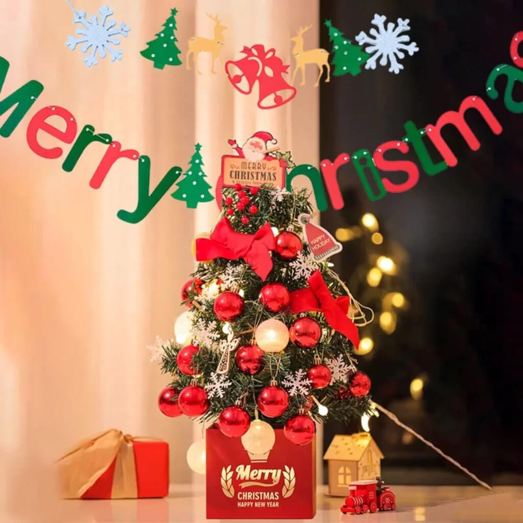 Merry Christmas paper banner with reindeer, bells, and Christmas trees hanging across wall decor