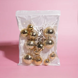 Mirrored gold cake balls in three assorted sizes