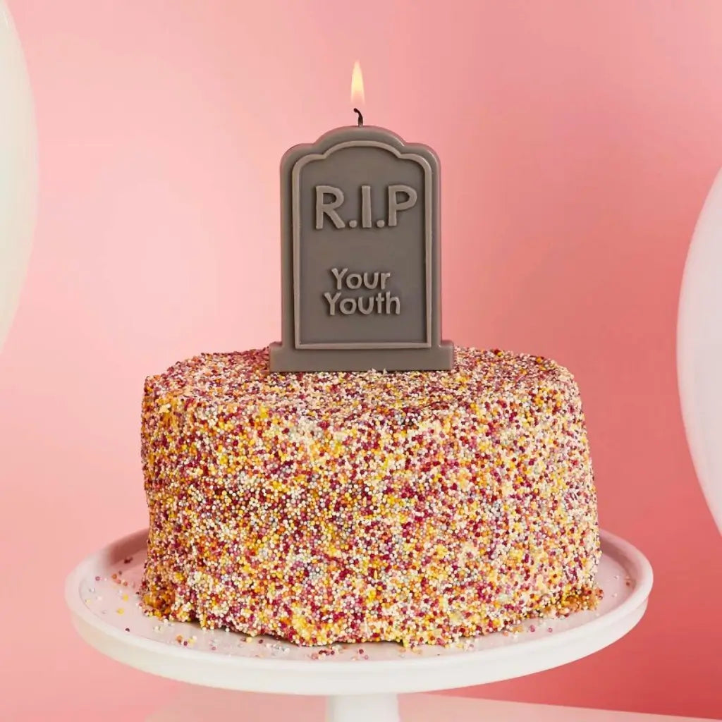 RIP Your Youth candle displayed on a birthday cake