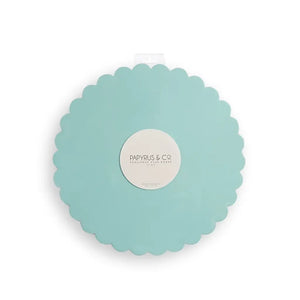 Round blue cake board with a decorative scalloped edge