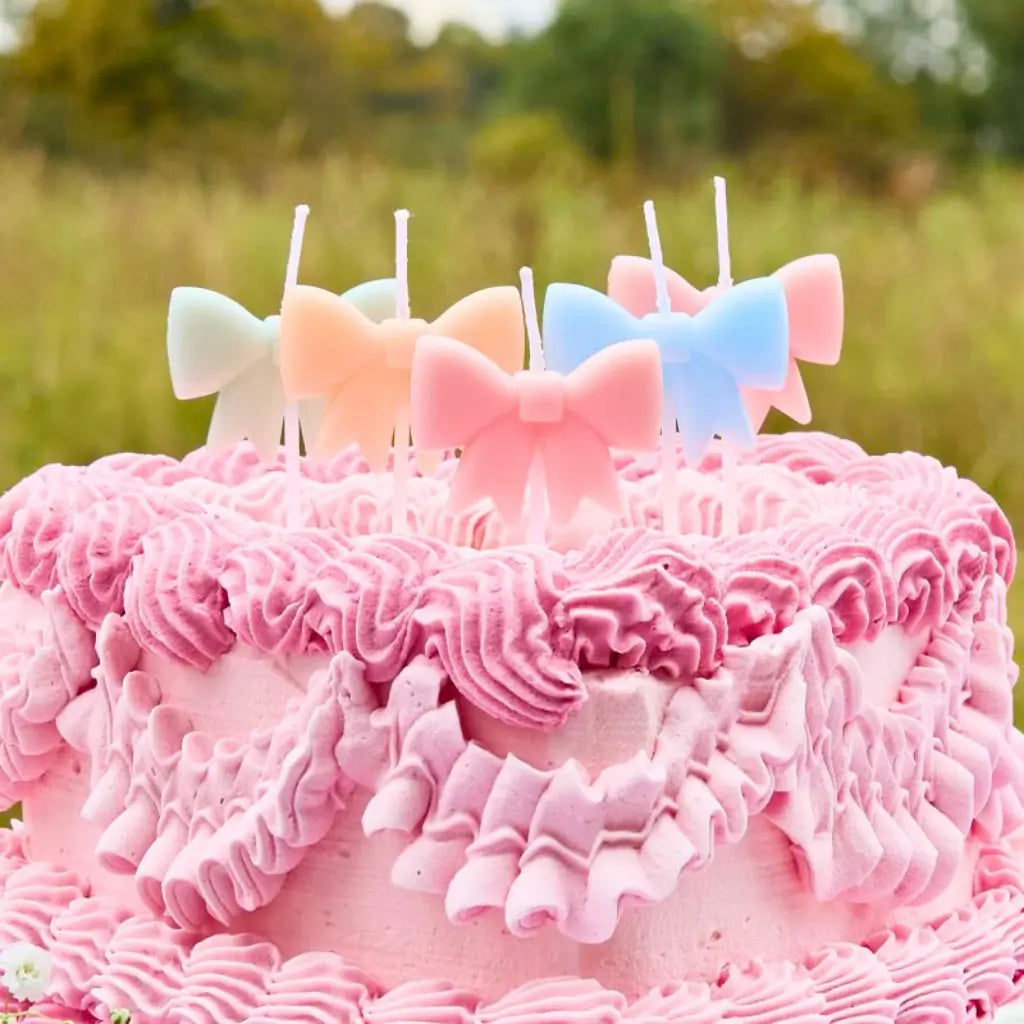 Pack of 5 pastel bow-shaped cake candles for tea party or baby shower