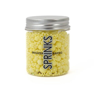 Pastel lemon cake decorations in wide-mouth jar