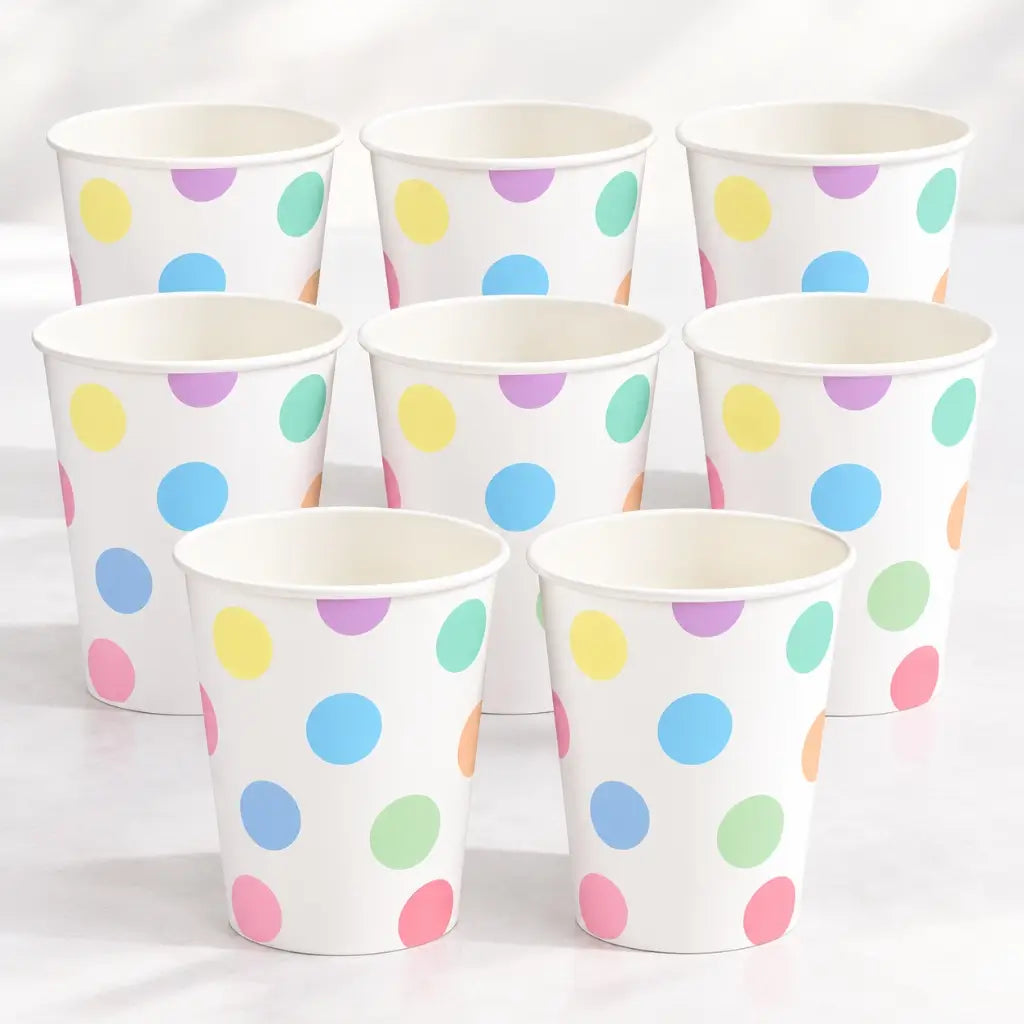 Pastel polka dot paper cup with colourful dots on white
