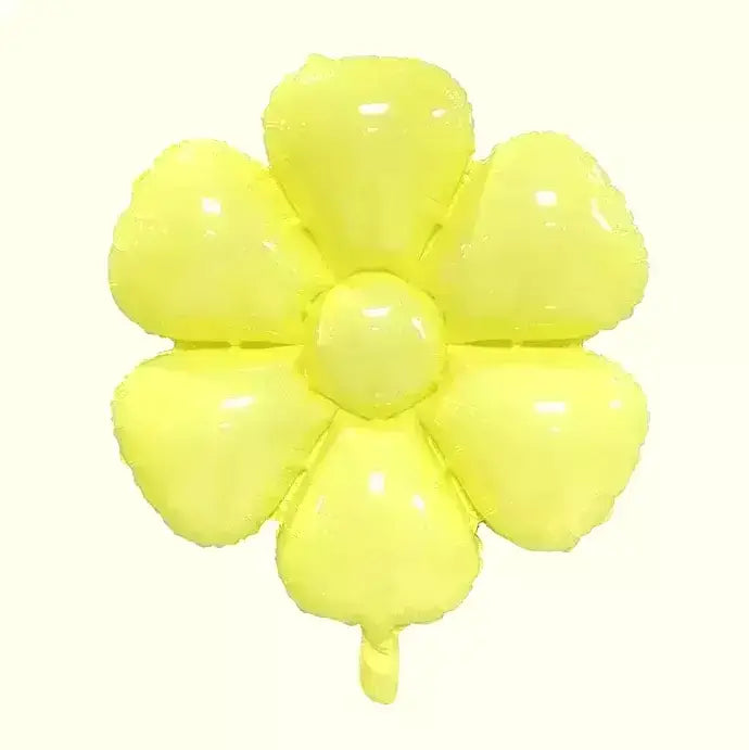Yellow flower-shaped balloon on a white surface with a light gray textured background