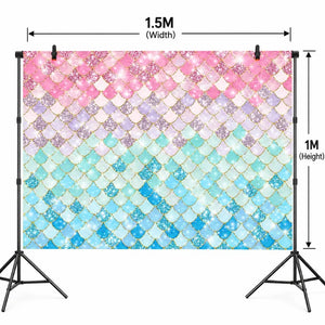 Pink and blue mermaid-scale backdrop for party photos and cake displays