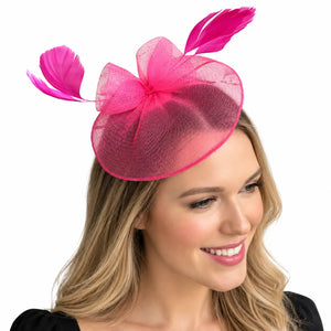 Pink mesh disc fascinator featuring a sculptural bow design