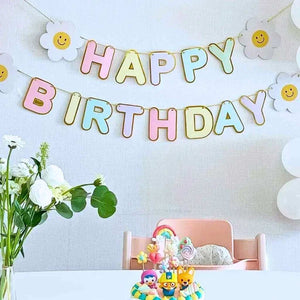 Rainbow Happy Birthday paper banner with four smiling daisy flowers