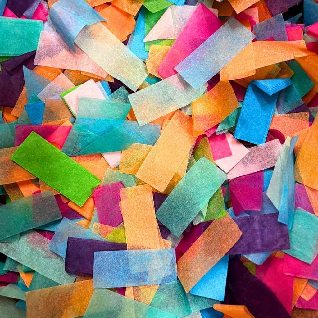 Colorful confetti pieces in various shades of pink, blue, green, orange, and purple.