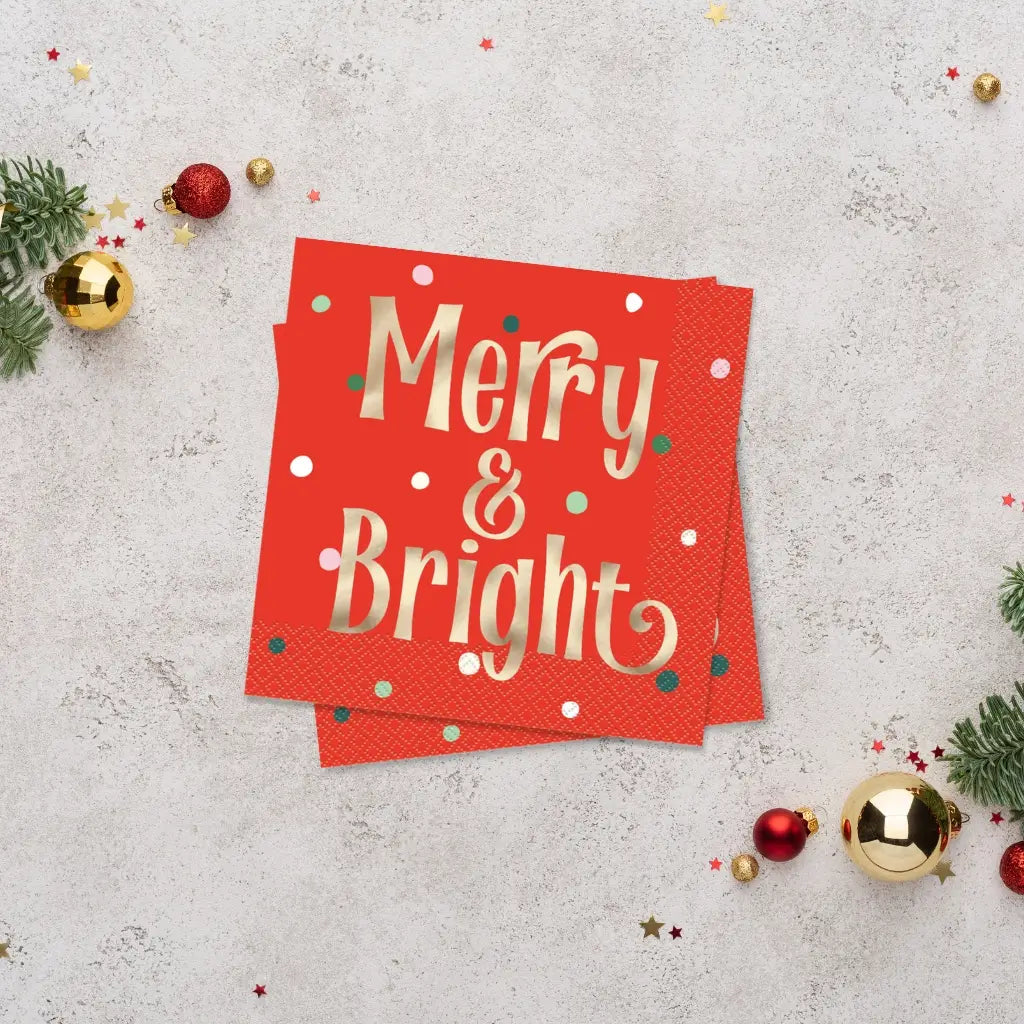 Red napkins with gold foil Merry & Bright lettering and dotted accents