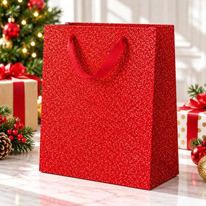 red Christmas glitter gift bag with matching ribbon handles