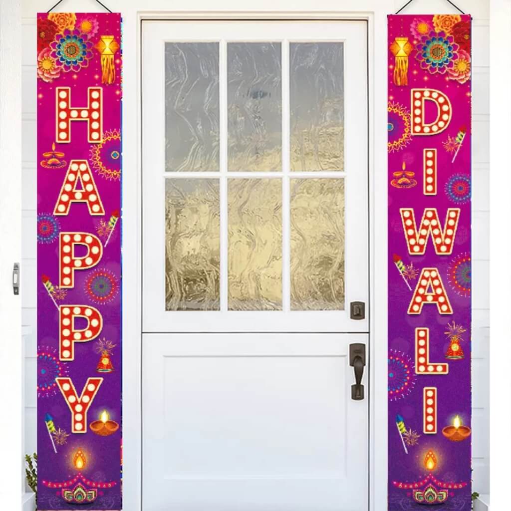 Decorative couplets  with 'Happy Diwali' text hanging on a door.
