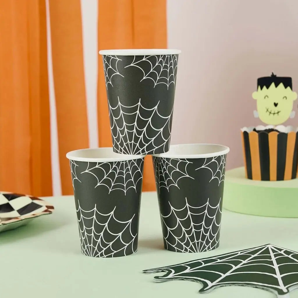 Black paper cups with white spiderweb Halloween design