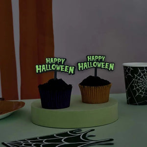 Retro Happy Halloween glow-in-the-dark cupcake toppers on black cupcakes