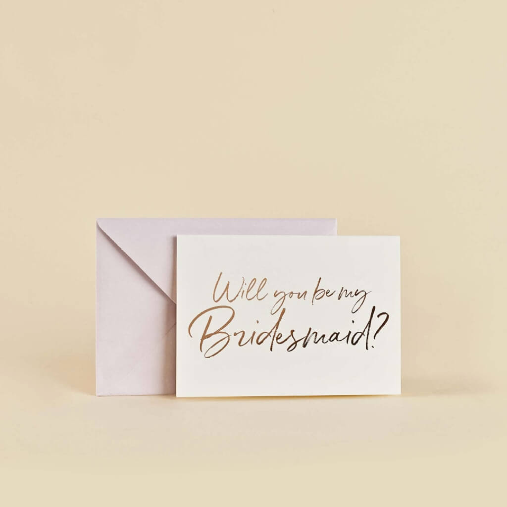 Rose gold foiled bridesmaid proposal cards with matching pink envelopes