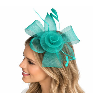 Teal mesh flower and feather fascinator headband worn to one side