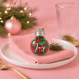 Sprinks Yuletide holly and berry sprinkles inside a glass JOY bauble