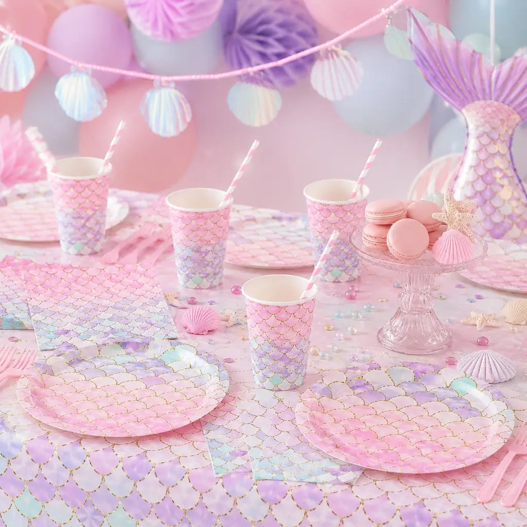 Pastel-colored party table setting with mermaid-themed plates, cups, and decorations.
