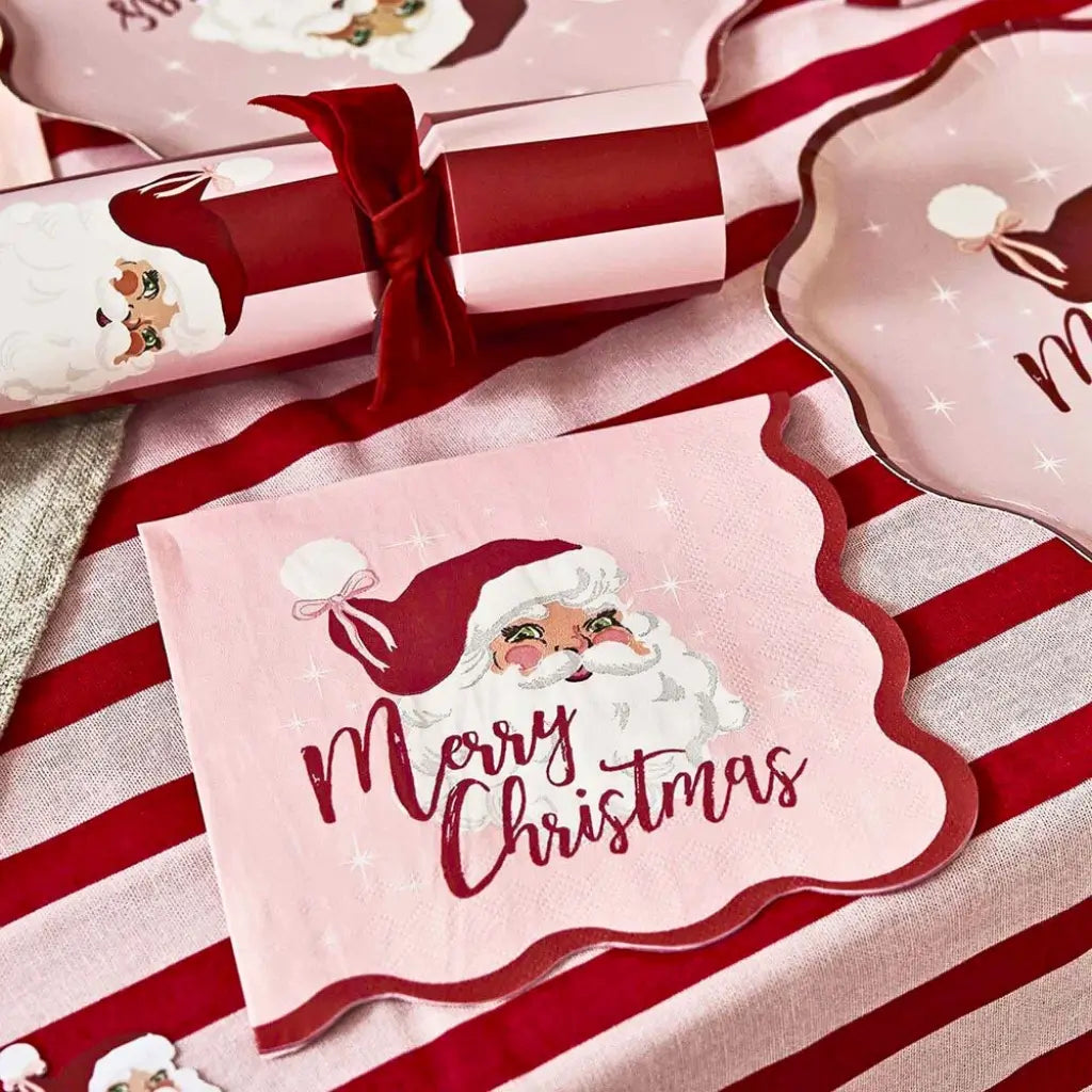 Vintage Santa paper napkins arranged on a Christmas dining table with festive decorations