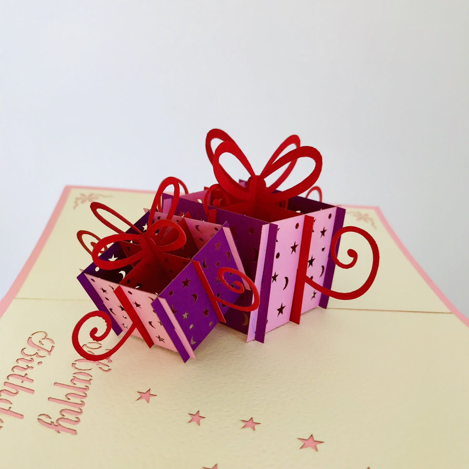 Pink and purple present boxes birthday pop up card