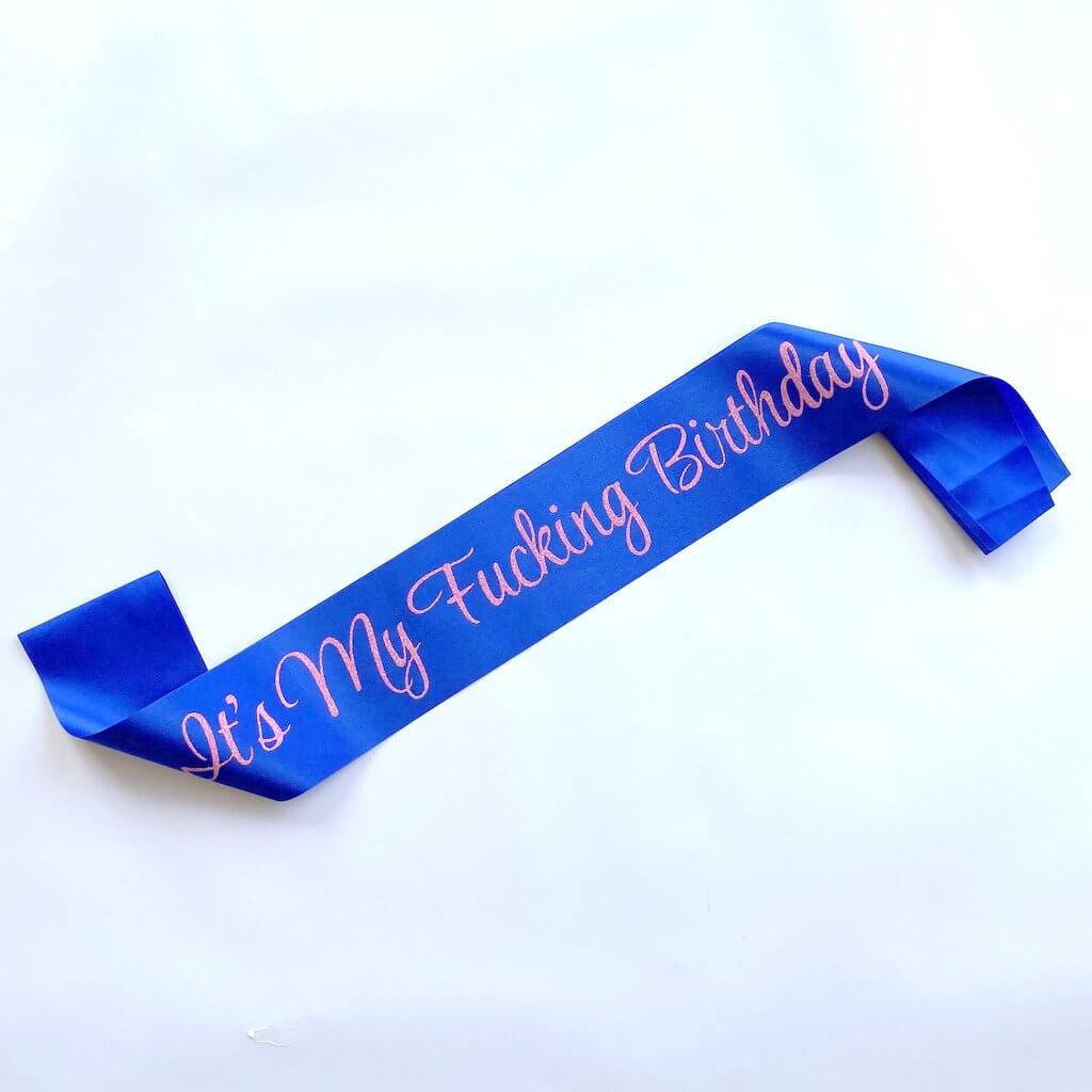Blue birthday sash with pink or gold glitter text It’s My F*cking Birthday
