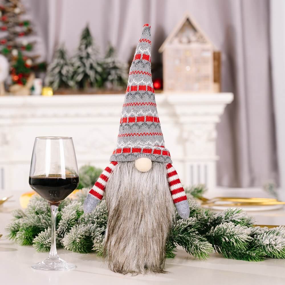 Knitted Scandinavian gnome wine bottle cover in red and grey with long beard for Christmas decoration